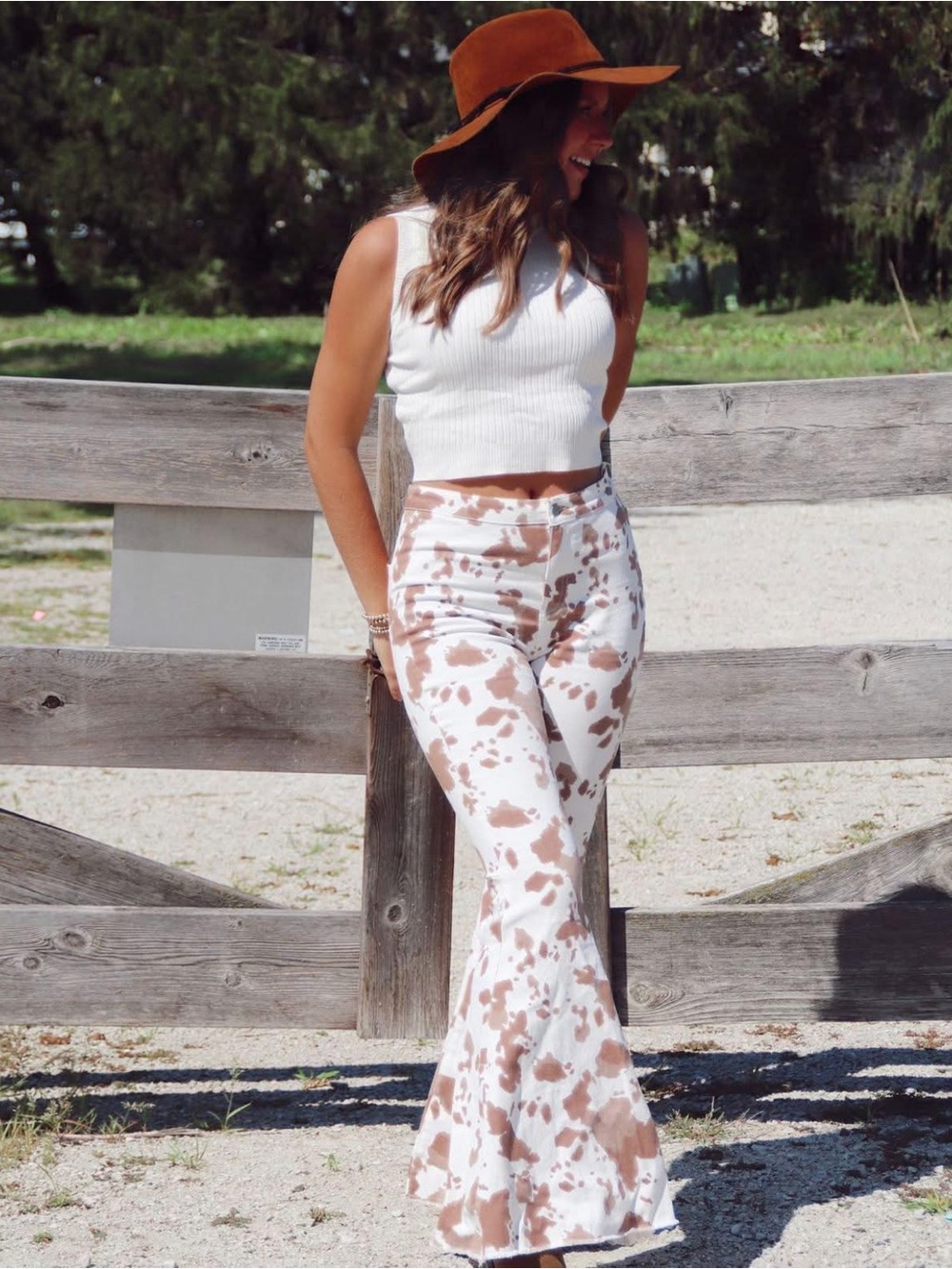 Altar’d State brown and white cow print flare pants with raw hem size XS